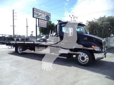 Kenworth T280 rollback truck side view showing flatbed and cab with chrome wheels.
