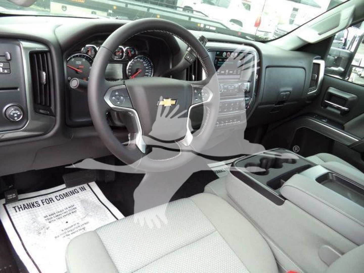 Chevrolet Silverado 6500HD interior showing steering wheel with Chevy logo, dashboard, and center console.