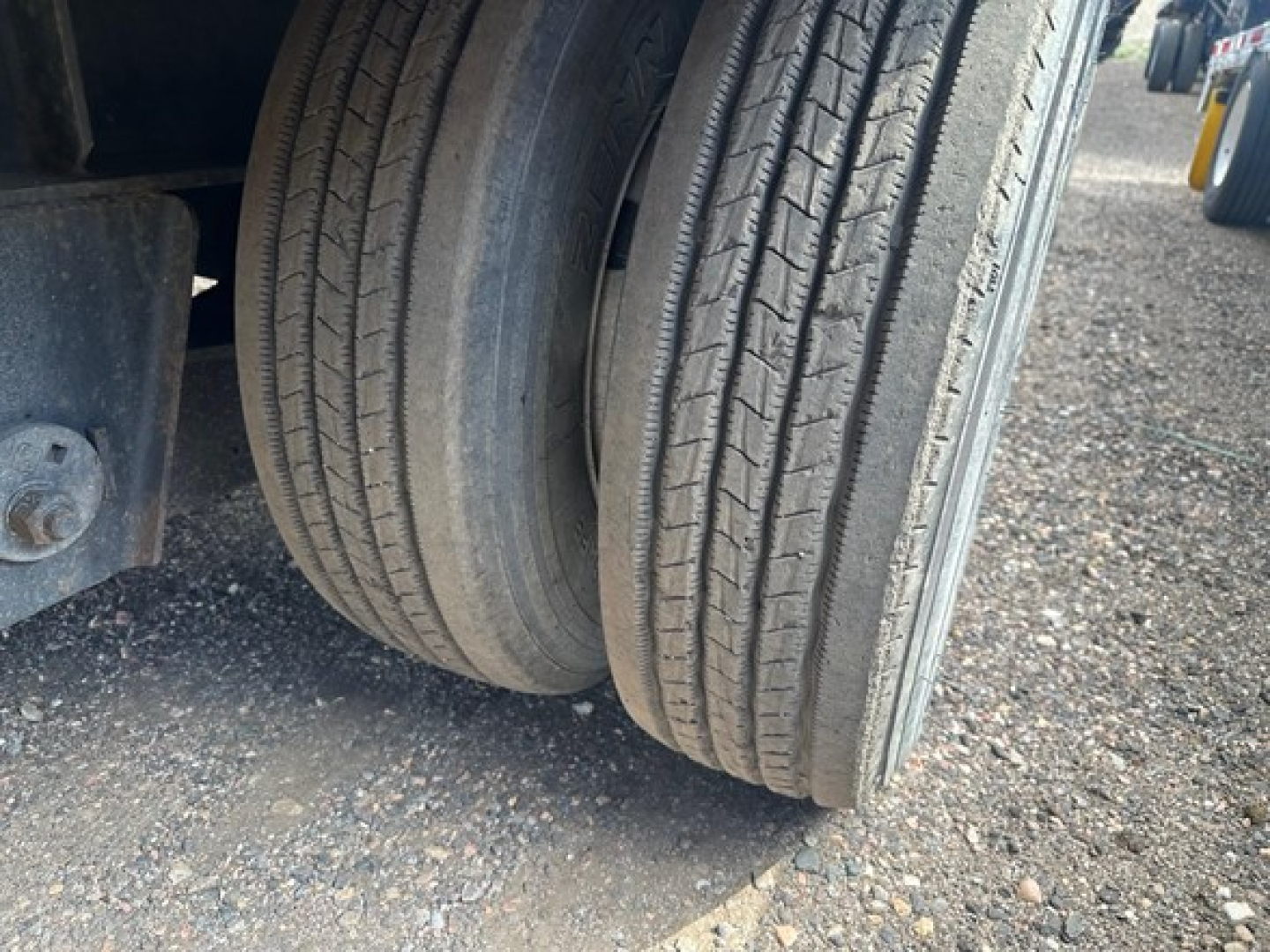 Dual rear tires of a Great Dane trailer with spread air drop deck visible.
