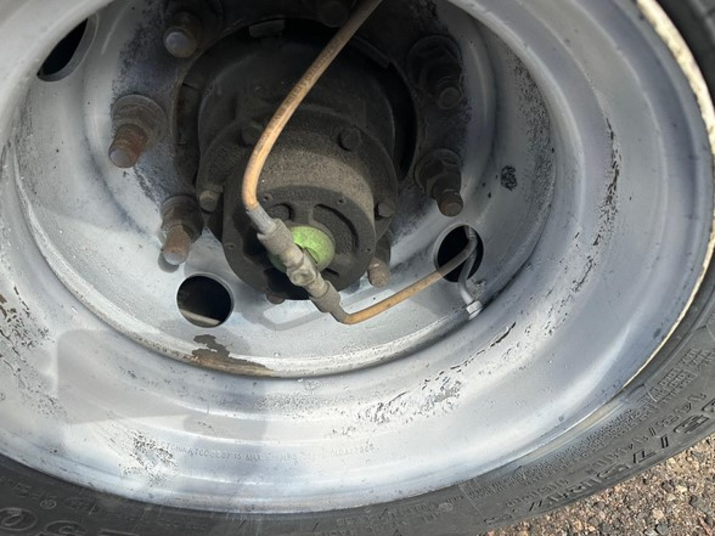 Wheel hub and axle area of a Great Dane steel spread air drop deck trailer showing hub, brake drum, and wiring.