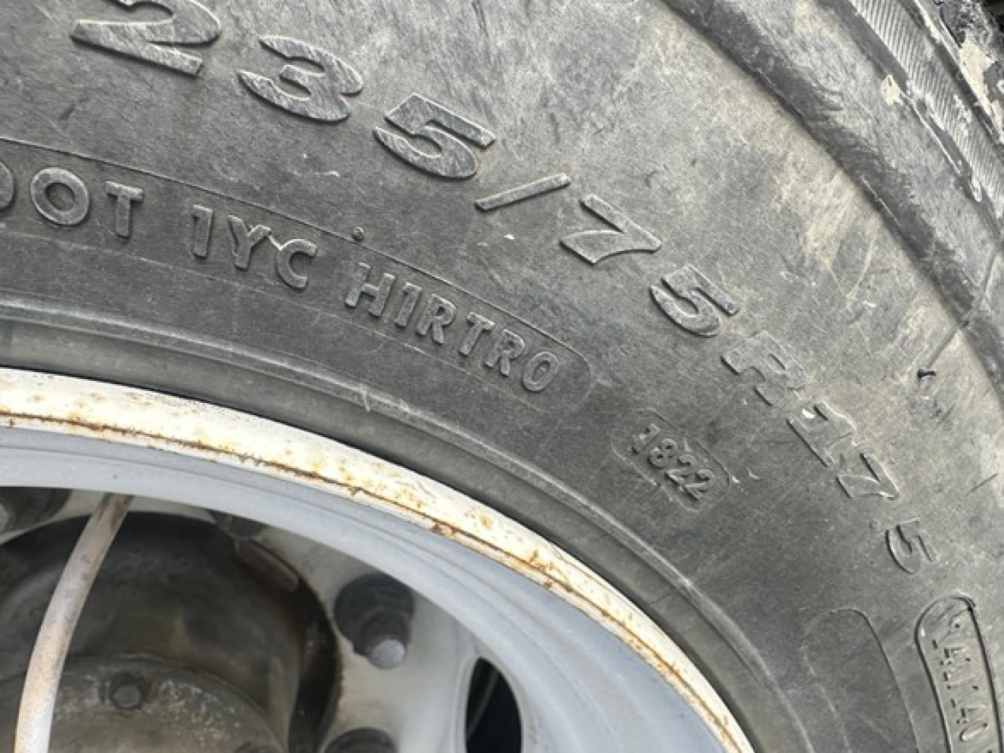 Great Dane trailer wheel close-up showing tire markings 235/75R15 and 10PR on sidewall with rim.