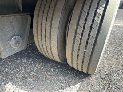 Axle area of a 2017 Great Dane steel spread air drop deck trailer showing dual tires and wheel well.