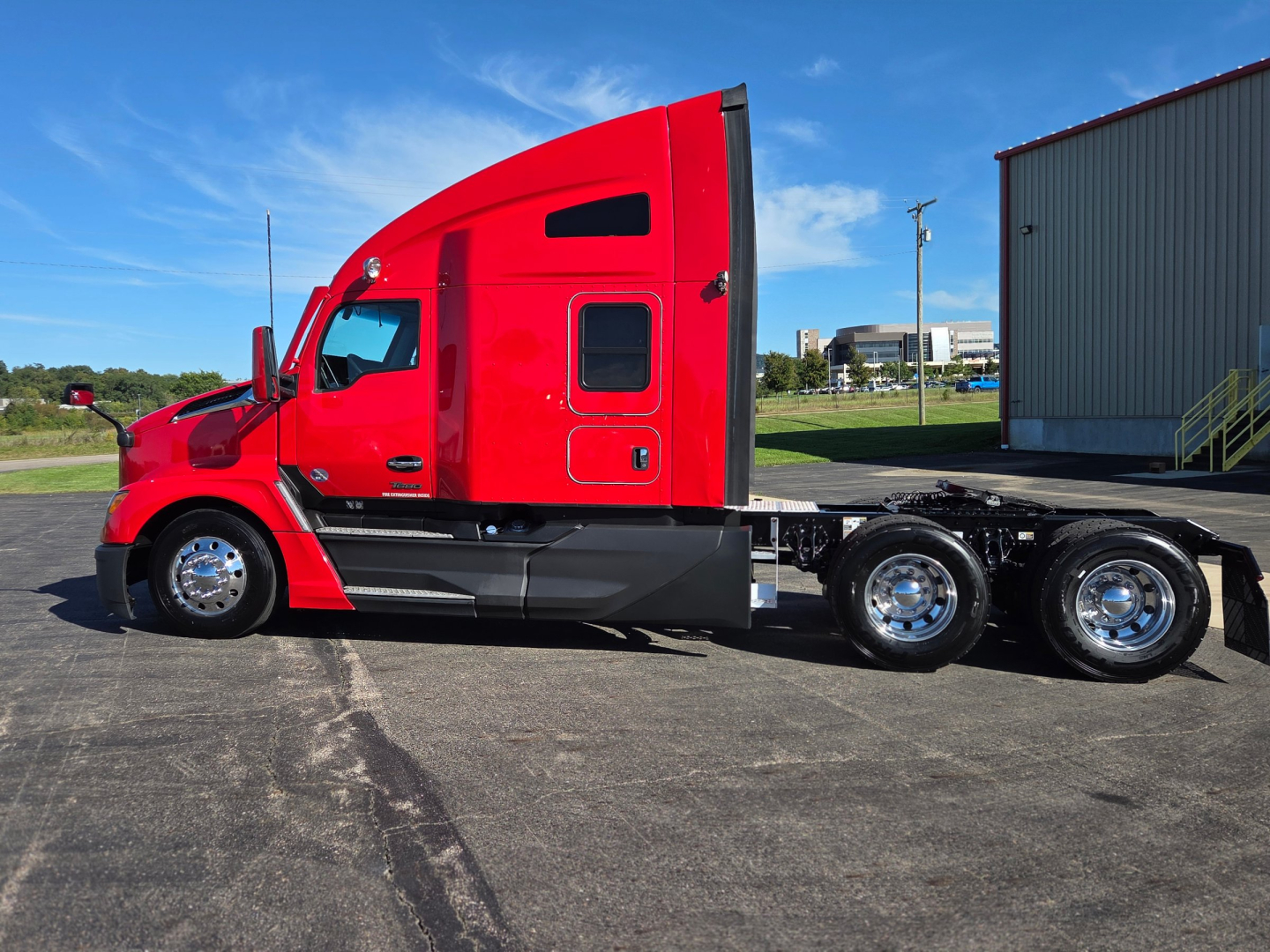 Kenworth T680 tractor in red side view showing sleeper cab, fuel tanks, and 3 rear axles chassis.