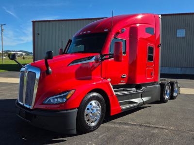 Kenworth T680 truck in red, side view showing cab, fuel tanks, chrome wheels, and dual rear axles.