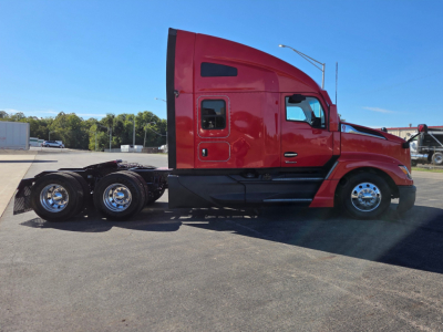 Kenworth T680 truck side view in red with sleeper cab, three rear axles, chrome wheels, and black chassis.