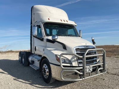 Freightliner Cascadia126 tractor cab front-left view showing chrome grille guard and high roof. Vehicle includes dual rear axles, white paint, and DOT-style mirrors.