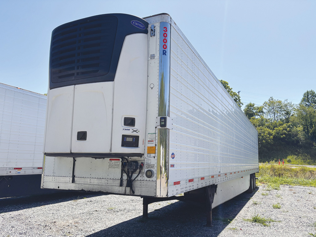 Utility reefer trailer with 3000R refrigeration unit, side view, white body, raised landing gear, VIN plate area visible.