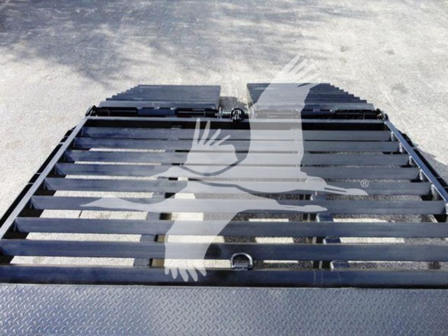 Flatbed truck platform showing metal slats and mounting points, Freightliner M2 106 equipment image with deck surface visible.