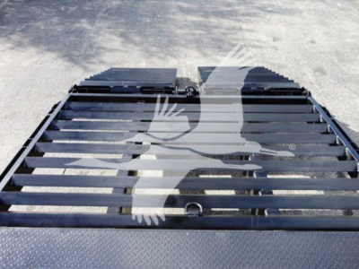 Flatbed truck platform showing metal slats and mounting points, Freightliner M2 106 equipment image with deck surface visible.