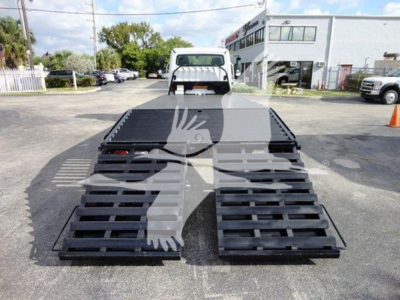 Flatbed truck with lowered ramps at the rear; 2015 Freightliner M2 106 equipment listing. Visible text on image not legible; VIN and stock not shown in image.