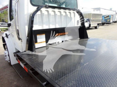 Flatbed tow truck2015 Freightliner M2 106 with metal diamond plate flatbed and white cab, rear view showing Jayco? Noting a large black protective bumper and reflective tape on sides.
