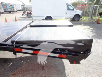 Flatbed truck bed of a Freightliner M2 106 with aluminum diamond plate surface and side rails.