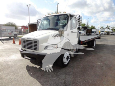 Freightliner M2 106 flatbed truck in view showing front and side, VIN 1FVACWDTXFHGR0070, stock TR0070, white cab with flatbed bed and dual rear wheels.