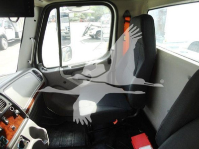 Freightliner M2-106 cab interior with steering wheel, dashboard wood trim, and front passenger seat visible.