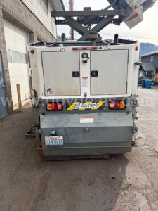 Rear view of a used 2007 Sterling SC8000 sweeper truck showing rear compartments, tail lights, bumper, license plate, and debris chute mechanism.