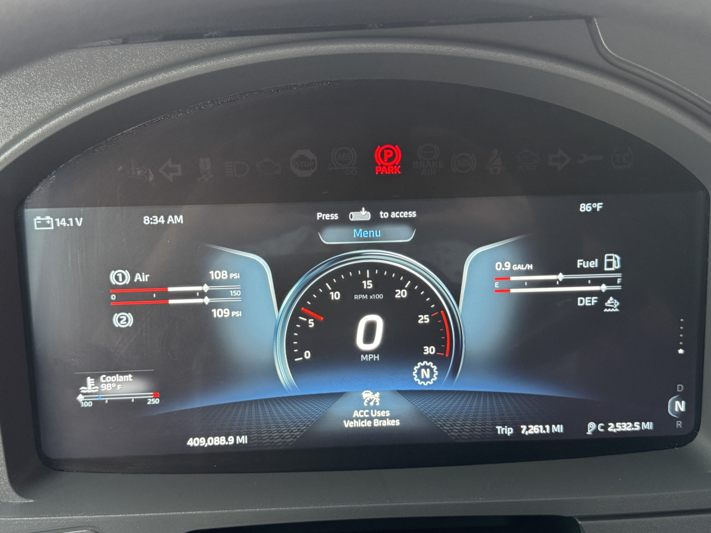 Kenworth T680 digital instrument cluster showing speedometer at zero, coolant, air, and fuel gauges, and vehicle information readouts.