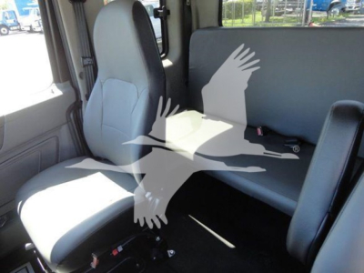 Interior of a 2022 International MV trucks cab showing front seat and rear bench seat.