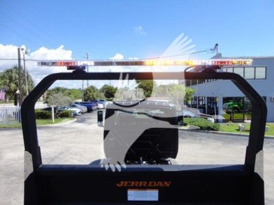 Rear view of a 2022 International MV rollback truck with an orange JERR-DAN logo on the bed and warning lights on top of the rack.