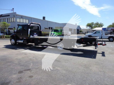 2022 International MV rollback tow truck in lot showing flatbed and cab with VIN 1HTEUMML7NH043803 on the listing image