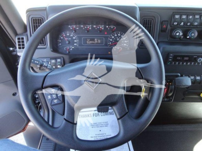 Truck cab interior showing steering wheel and instrument cluster.