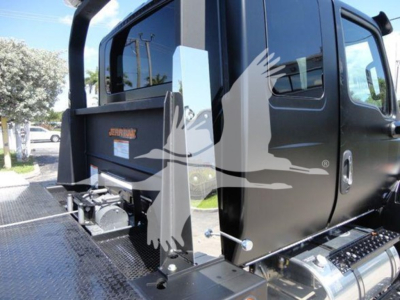 Truck cab rear and side with 'Jerr-Dan' label on black equipment, platform and hydraulic components visible near rear cab.