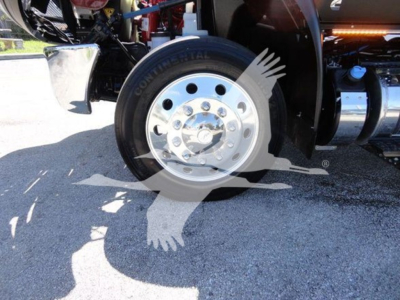 Truck wheel and front suspension visible with Conti tire branding; chrome hub and lug nuts. Partial undercarriage with black components.