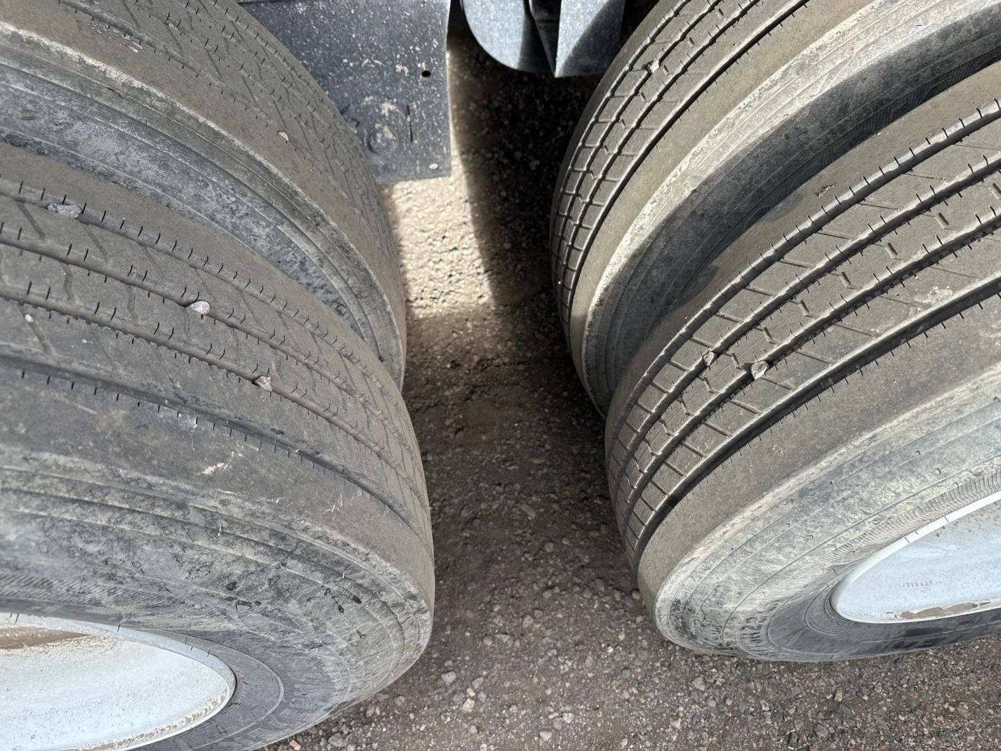 Rear axle dual tires of a Wabash flatbed trailer showing tread and sidewalls.