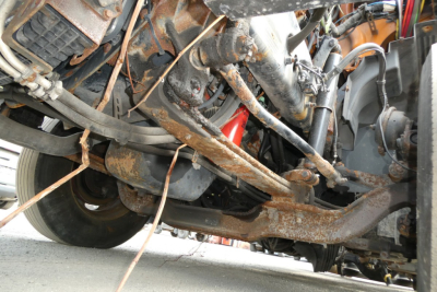 Underbelly of a Volvo VNM42T conventional daycab showing rusted chassis, suspension, and exposed components.