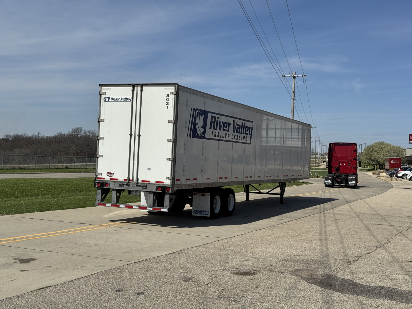 Trailer rear and side view showing River Valley Trailer Leasing logo on a Wabash Duraplate trailer with white exterior, dual rear doors, and a long rectangular cargo area.