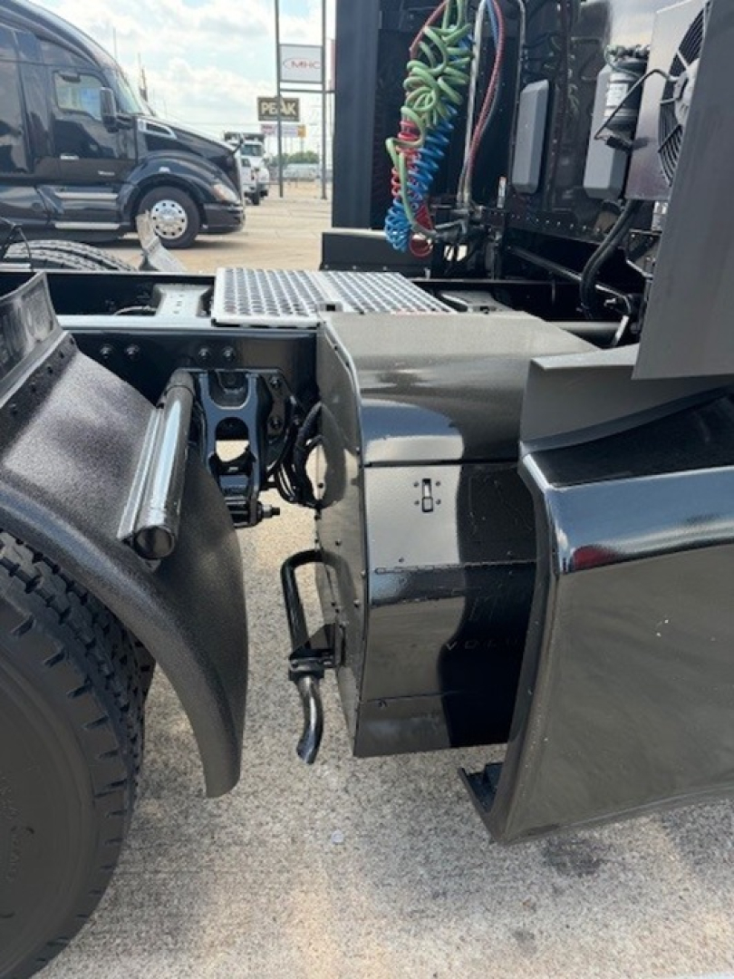 Kenworth T680 chassis side showing fuel/tank area and undercarriage components.