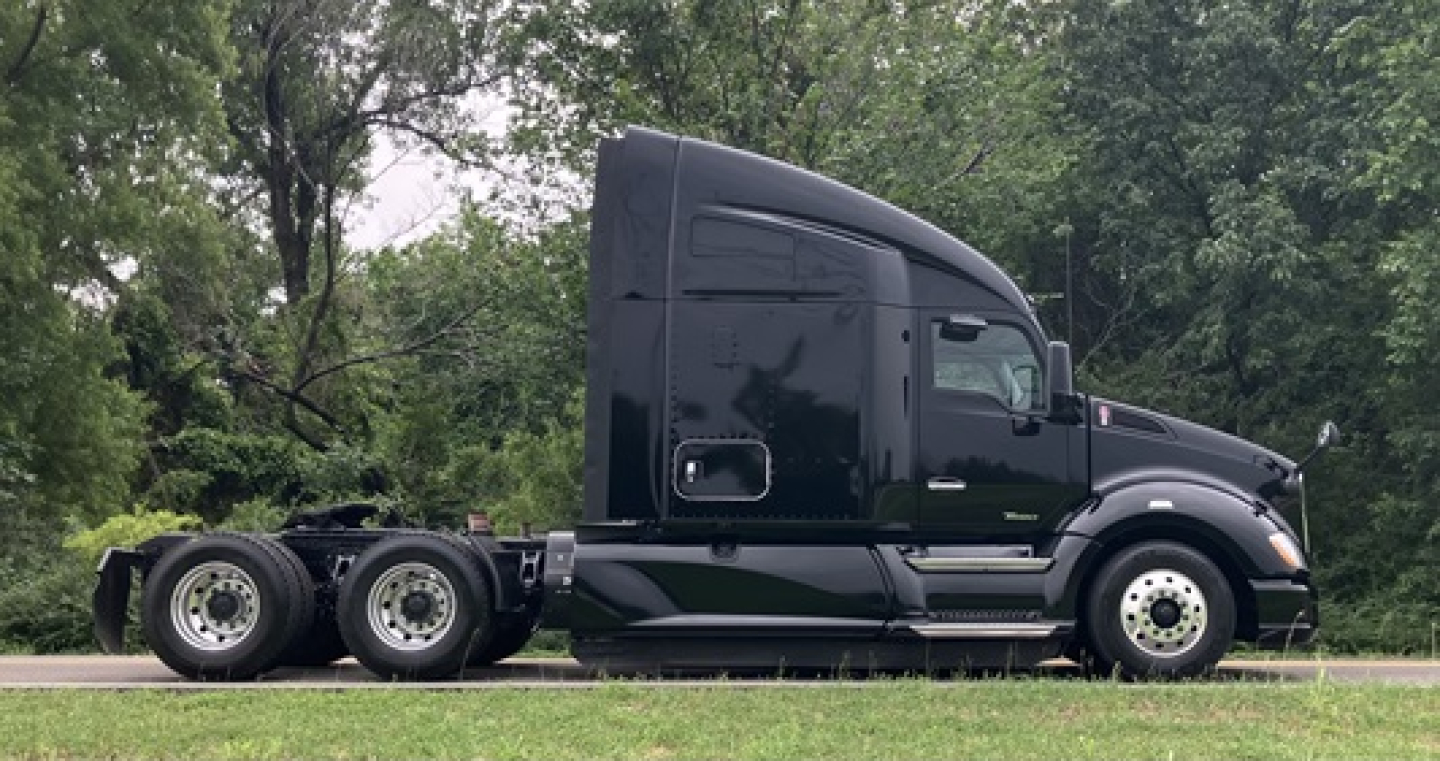 Kenworth T680 tractor side view showing sleeper cab and dual rear axles. Visible text: none legible.