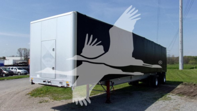 Trailer side view showing curtainside trailer with white rear and black sides. Visible text includes stock number 7679 and model type 'Curtainside' in listing.