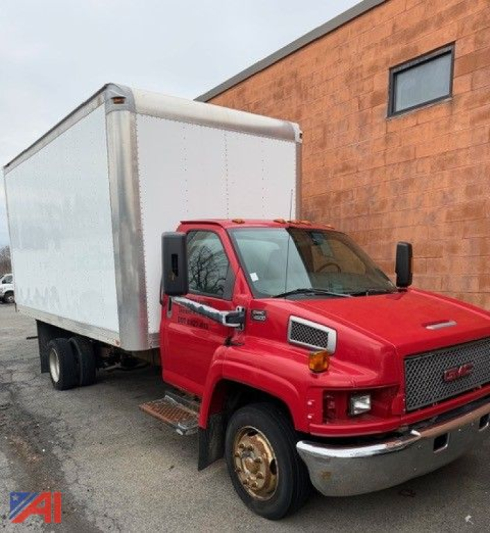 GMC TopKick C4500 box truck, red cab, white box, side view showing front and cargo area.