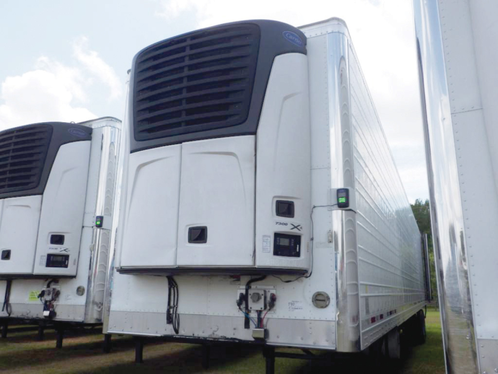 Trailer rear view showing a Wabash ArcticLite refrigerated trailer with V-bay unit and rooftop cooling unit.