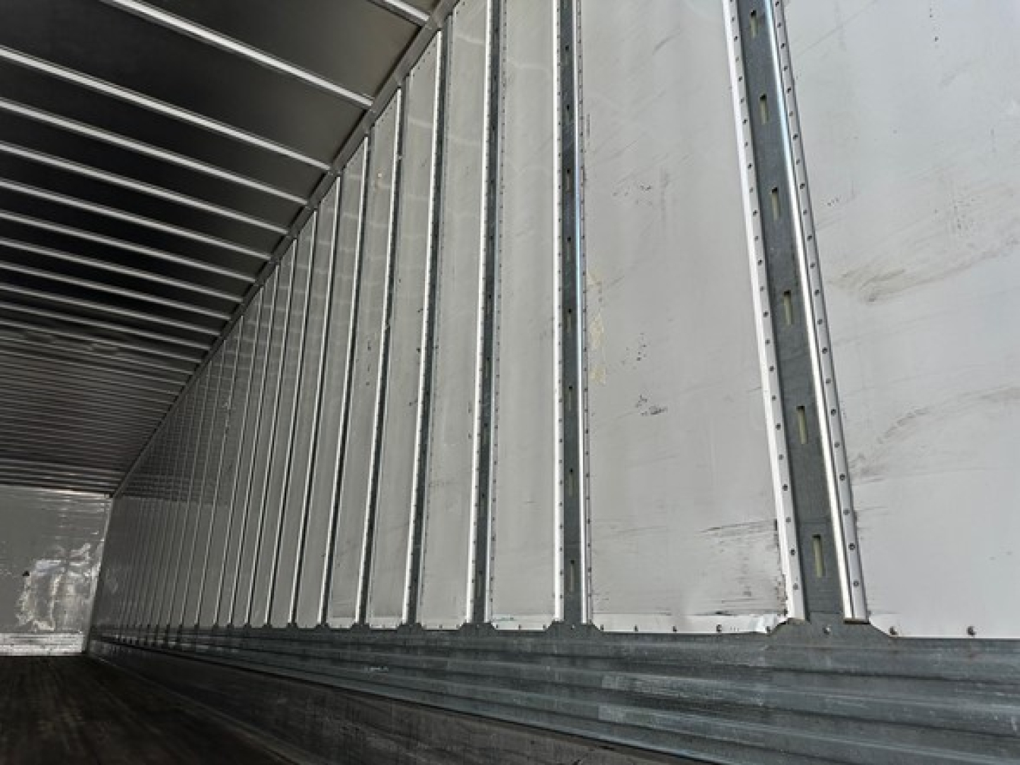Trailer interior showing corrugated metal sidewalls and ribbed ceiling of a Utility 4000dx trailer.