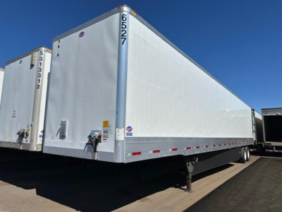 Utility 4000dx trailer showing side panel and front nose with JONT branding and registration tags.