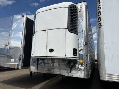 Utility reefer trailer showing front cooling unit and surrounding chrome side panels.