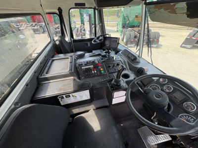 Cab interior of 2019 Autocar XPEDITOR showing steering wheel, control panel, joystick, gauges, and digital display.