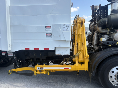 Autocar XPEDITOR rear view showing hydraulic hooklift arm attached to truck body