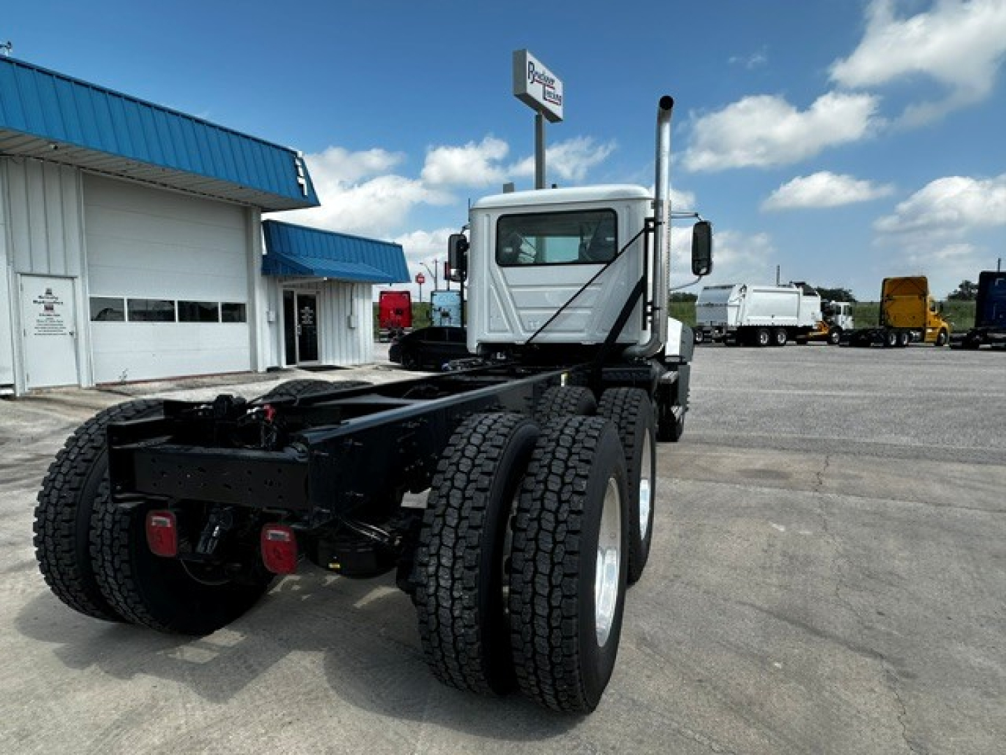 Mack GR64F chassis showing rear view with dual rear wheels and cab in background.
