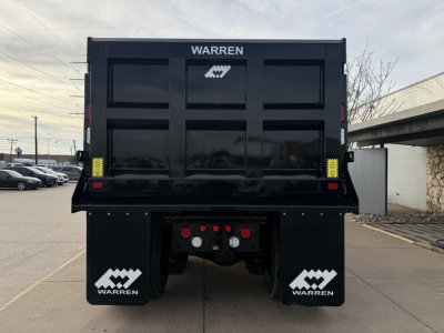 Dump truck bed rear showing Warren logo and taillight cluster on a new Mack GR64F dump truck.