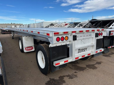 Trailer, 2020 Dorsey Giant flatbed trailer showing dual rear wheels, Dorsey branding on mudflaps and rear bumper, red and white reflective tape, metallic frame.