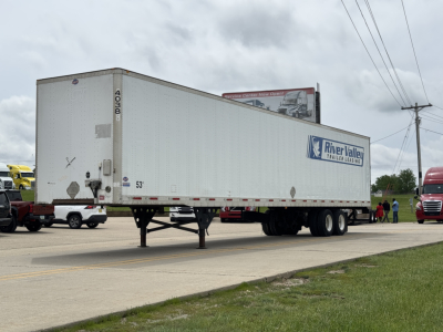 Trailer side view showing River Valley trailer logo, 53' length, dual rear axles, landing gear down, white exterior with DOT markings.