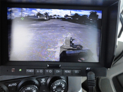 Kenworth W990 dashboard display showing view from the rollback truck with control buttons and HDMI/AV port visible.