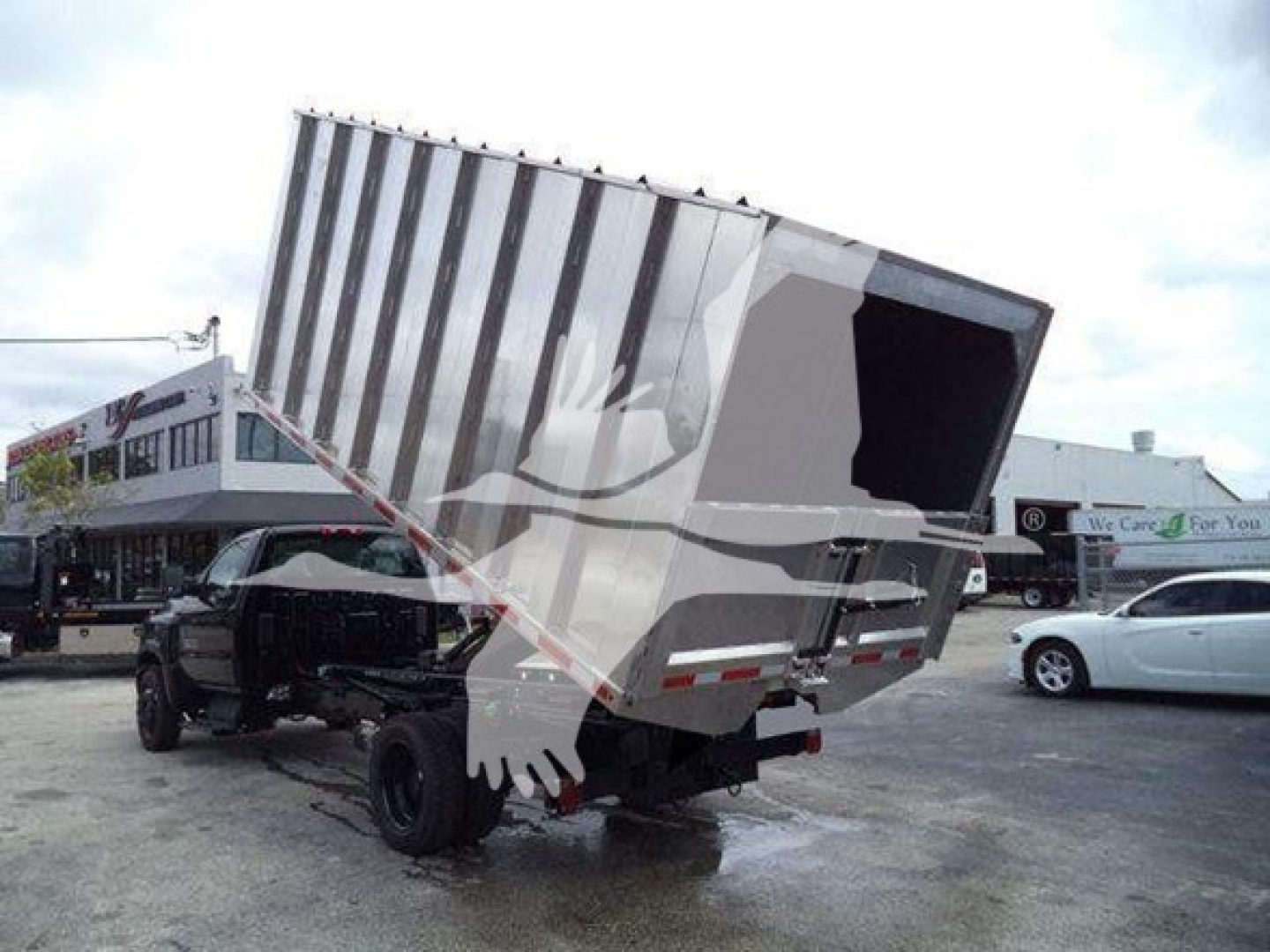 Truck chassis with a raised dump bed, rear dump opening visible, Silverado 6500HD