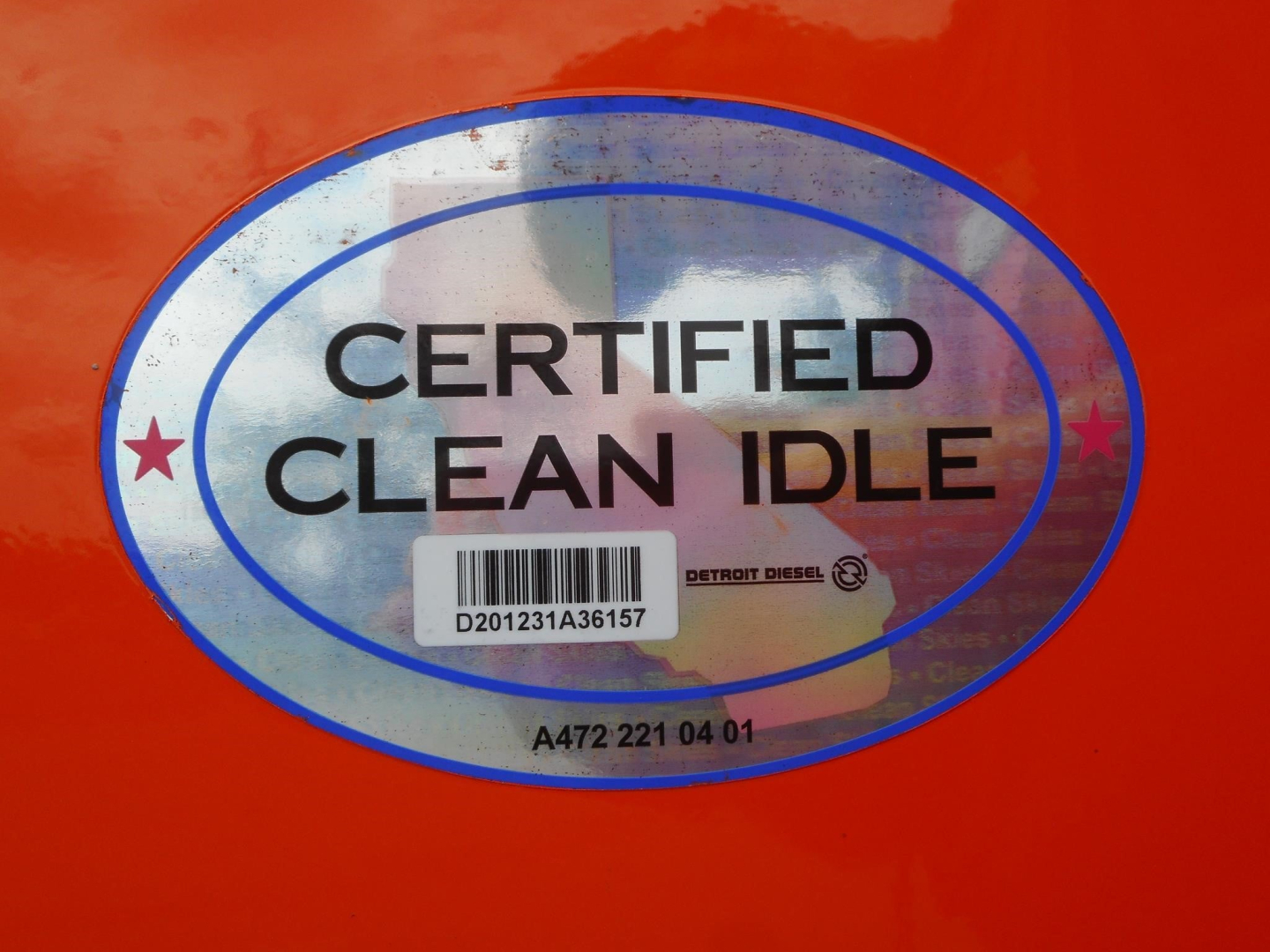 Sticker on truck showing CERTIFIED CLEAN IDLE with barcode and Detroit Diesel text.