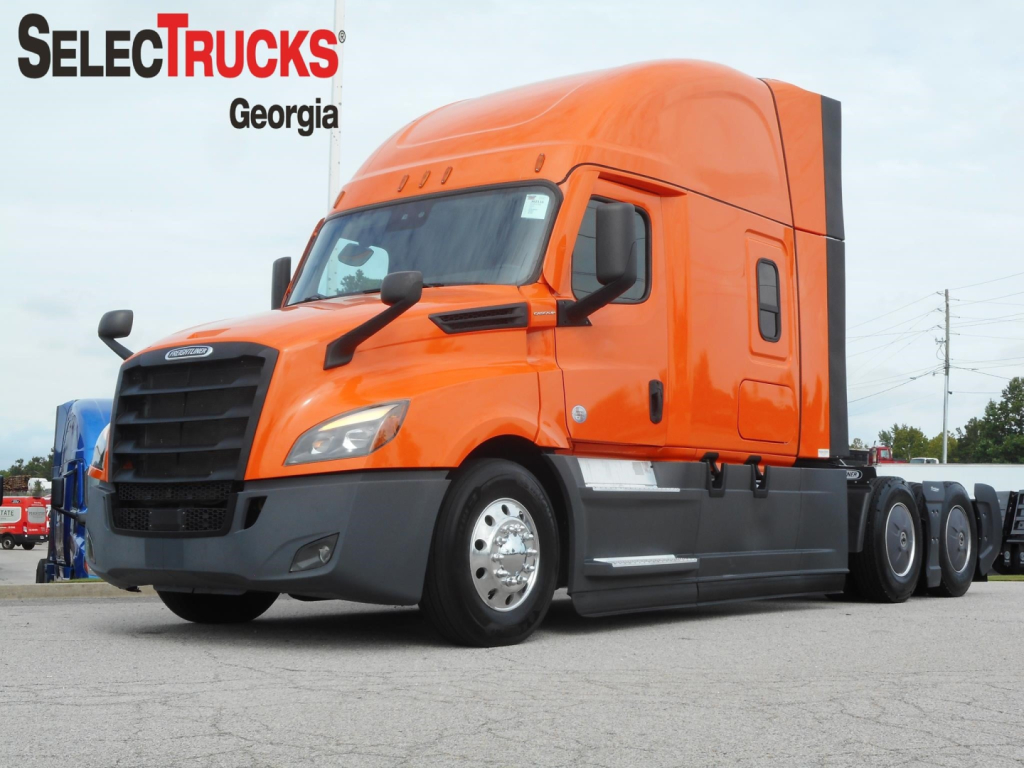 Truck image: orange 2022 Freightliner Cascadia tractor with sleeper cab, front-left view, logo and wheels visible.