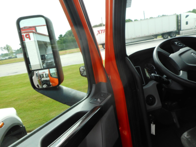 Truck cab interior door area of a 2022 Freightliner Cascadia showing side mirror and window controls.