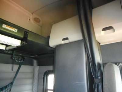 Freightliner Cascadia cab interior showing overhead bunk area and storage compartments