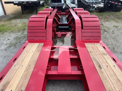 Fontaine 55 LCC lowboy trailer frame showing red steel chassis and wood deck sections.